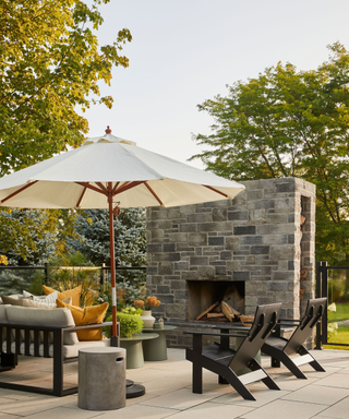 Parasol in small patio with discreet log storage