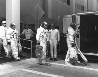 On July 16, 1969, astronauts Neil Armstrong, Buzz Aldrin and Michael Collins lifted off from Earth. Four days later, Armstrong and Aldrin became the first humans to walk on the moon. Here, the three suit up for a countdown demonstration test.