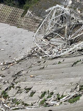 Damage sustained at the Arecibo Observatory 305-meter telescope. The top section of all three of the telescope's support towers broke off. As the 900-ton instrument platform fell, the telescope's support cables also dropped.