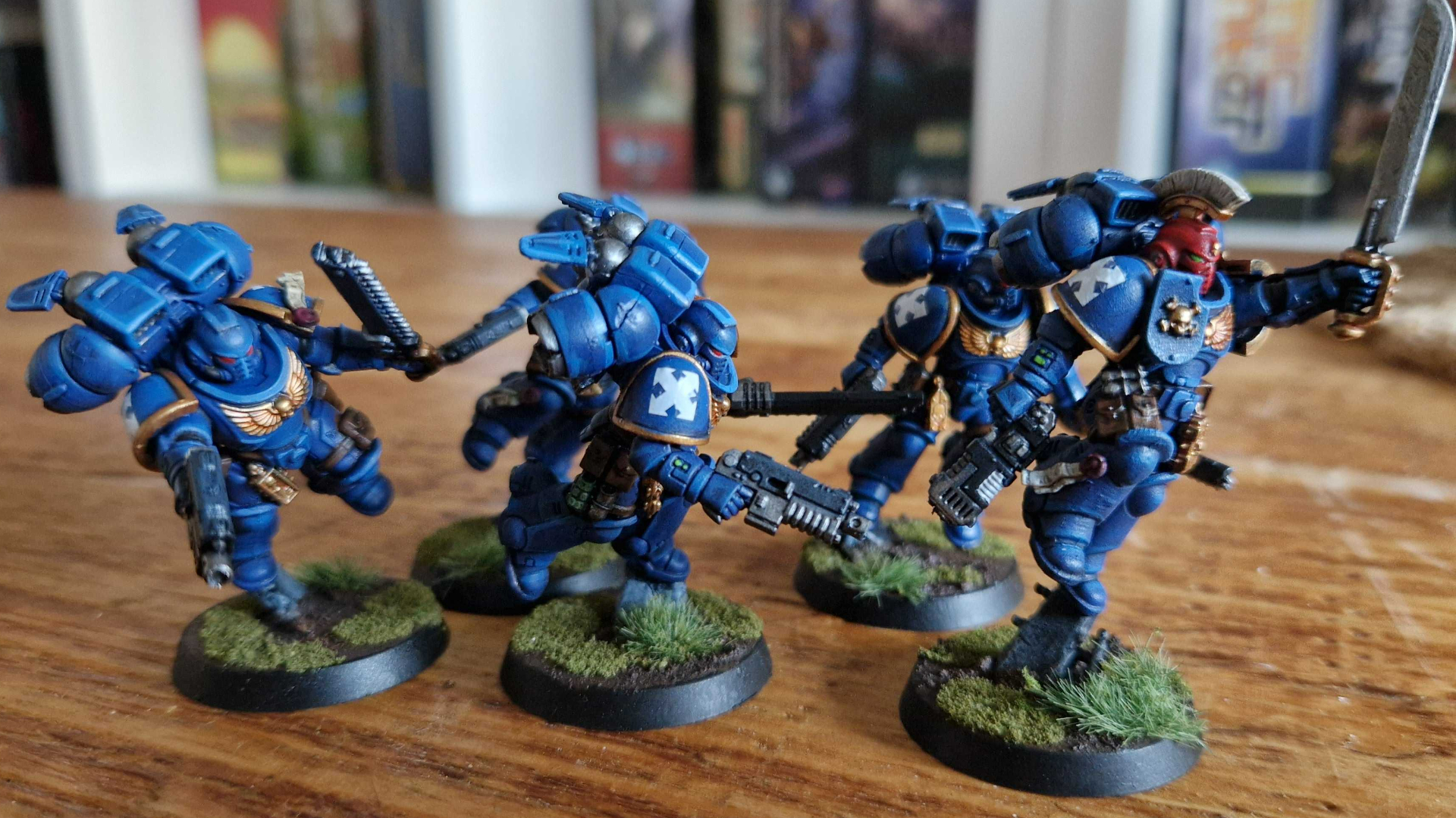 A group of painted Ultramarines on a wooden table