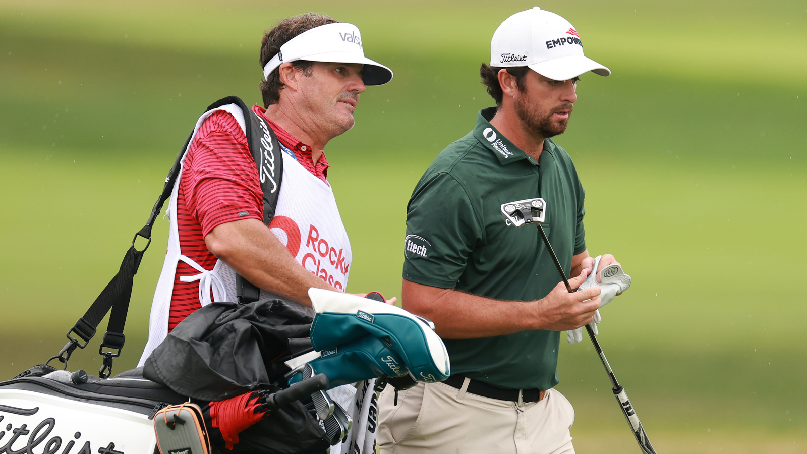 Davis Riley and his caddie walk off the green