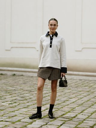 woman wearing a rugby shirt in Paris at Paris Fashion Week