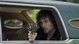 Martin Rodriguez as Rivi in a car with a gun in Griselda episode 5