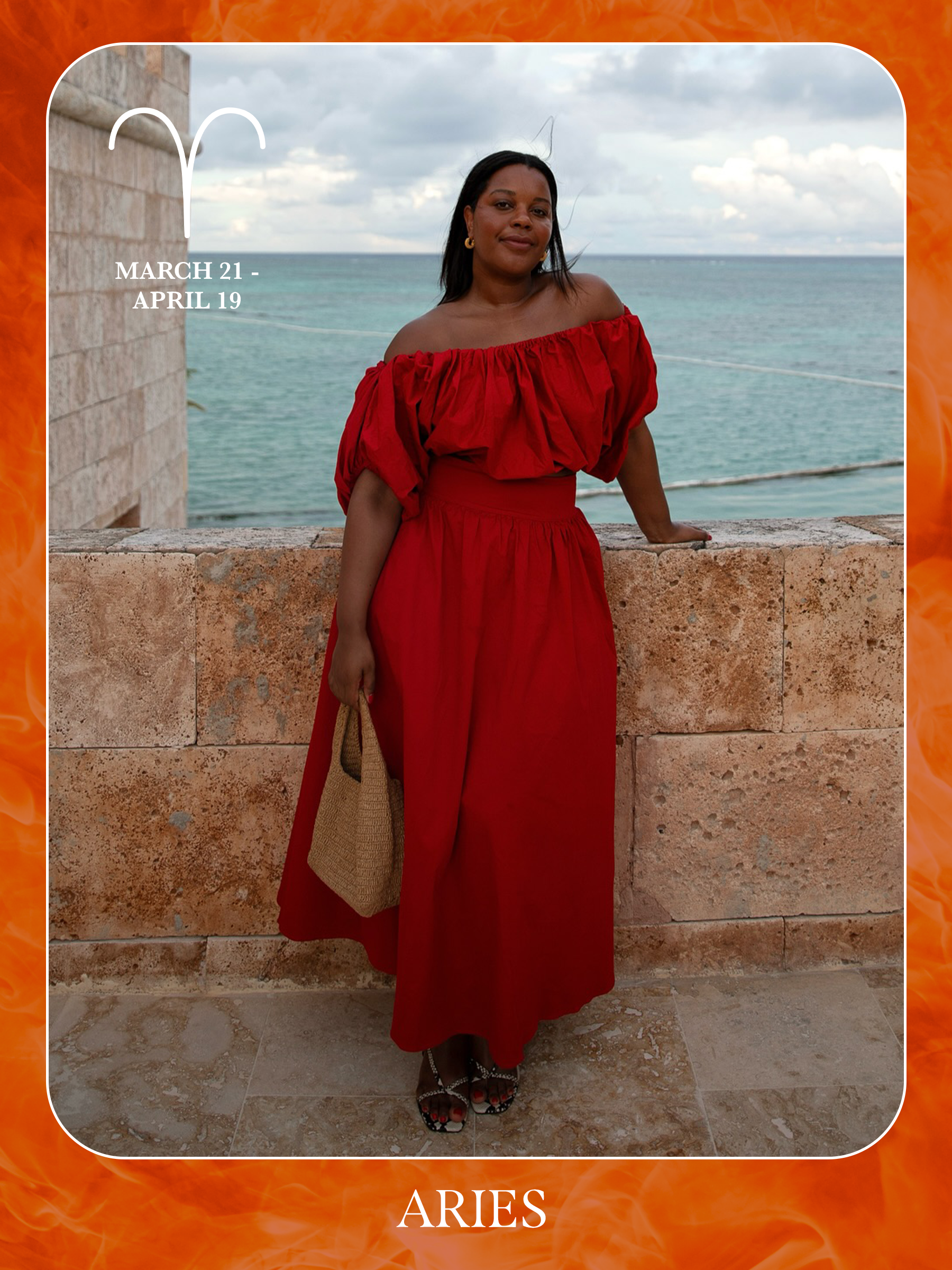 An image of @styleidealist posing on a beach wearing a red dress, showcasing the characteristics of sun sign dressing if you're an Aries.