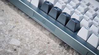 A photo of the Keychron Q1 Pro in gray aluminum with white, black and purple keycaps.