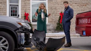 Rebecca Dalton and Jonathan Keltz look at a broken bumper in Christmas by Design