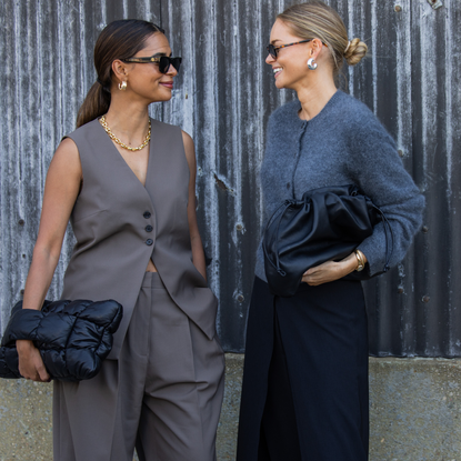 Emelie Lindmark wears grey vest, pants, black bag & Claire Rose Cliteur wears grey cardigan, black bag, pants outside Cos during New York Fashion Week on September 10, 2024 in New York City.