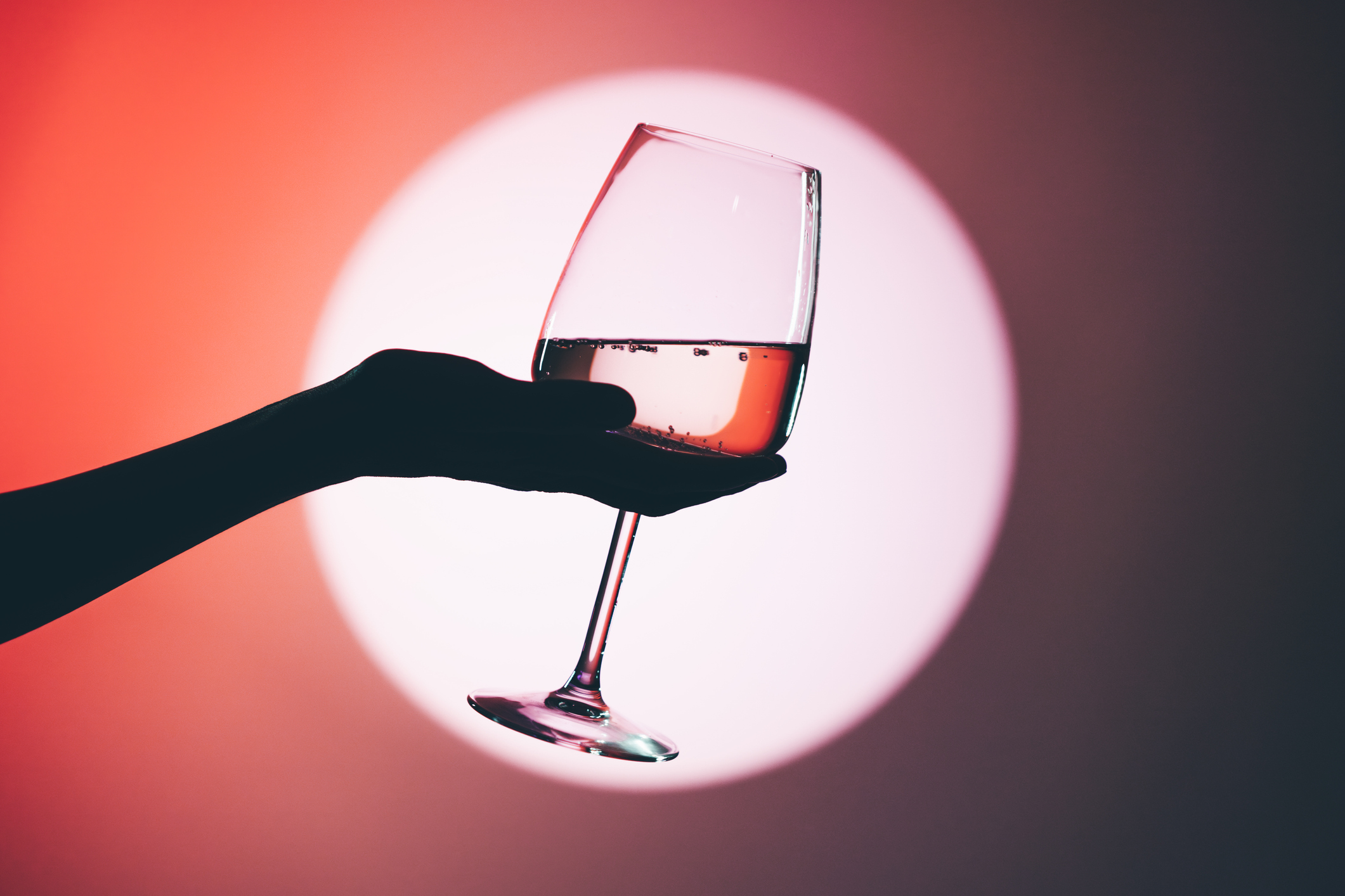 Fine wine in a glass held by a woman