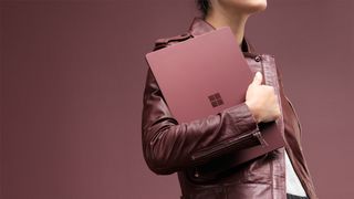 Woman carrying Microsoft Surface Laptop