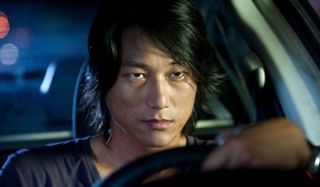 The Fast and The Furious: Tokyo Drift Han scowling behind the wheel of his car