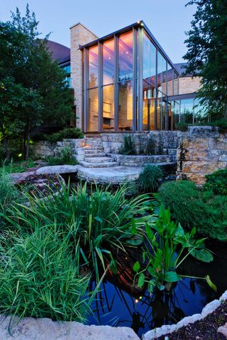garden pond ideas: modern house with steps down to pond