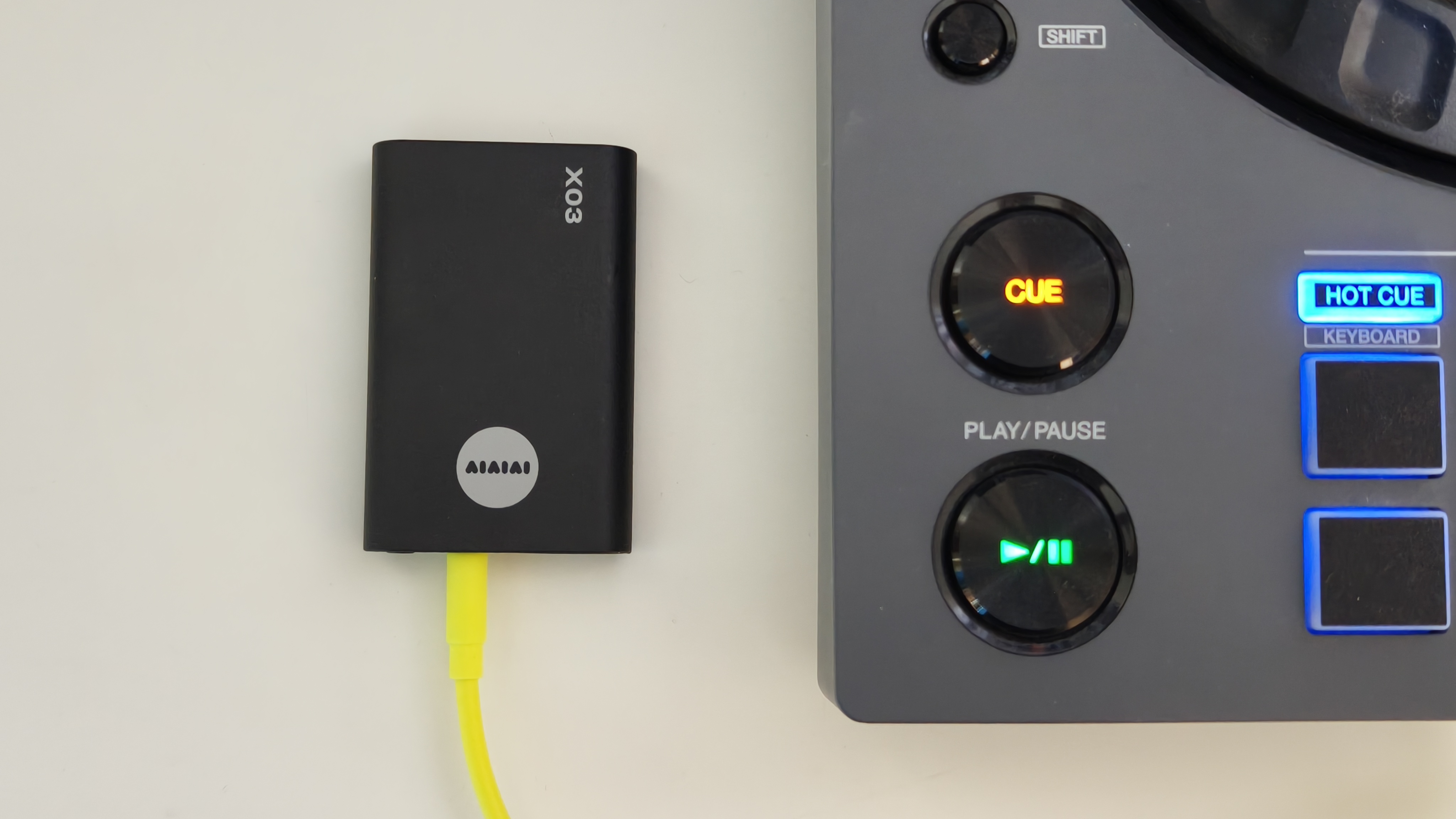 A wireless transmitter by the corner of a DJ controller