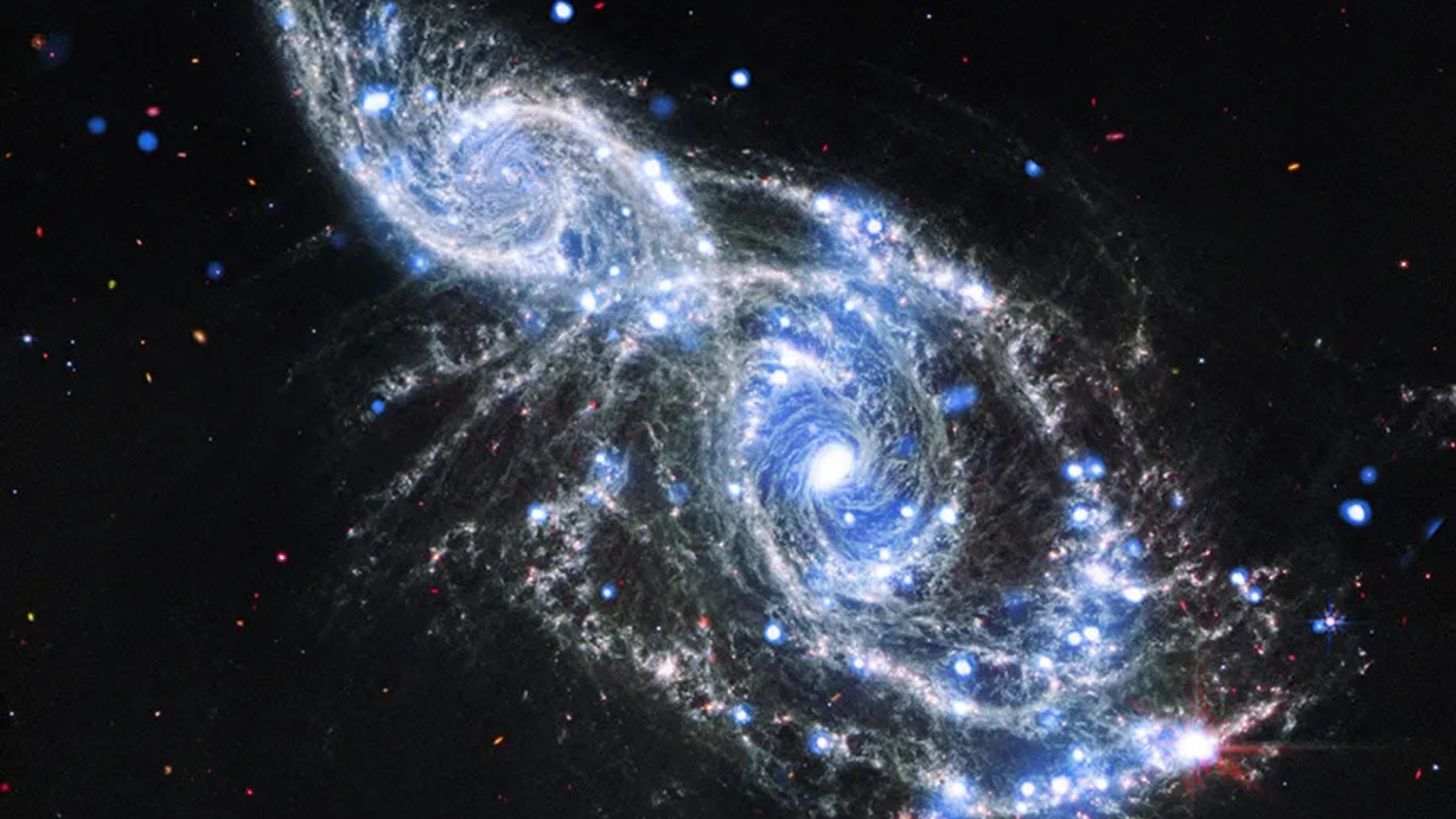 Two blue and white spirals of light are intertwined in the darkness of space