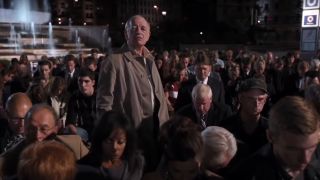 Kenneth Tigar stands defiantly among a kneeling crowd in The Avengers.