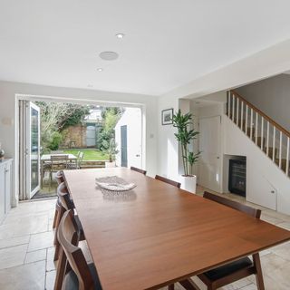 dining area with white wall and open garden
