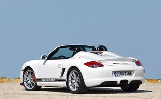 Rear view of a white Boxter Spyder with the top down