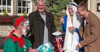 David Metcalfe tells Frank Clayton and Tracy Metcalfehe wants to fundraise for his cancer ward, not do a skydive. Frank wants to help and dresses as an elf with a sign inviting people to throw foam pies at him for charity. But unseen by Frank, Bobby gets off the bus in Emmerdale.