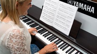 Woman playing Yamaha digital piano