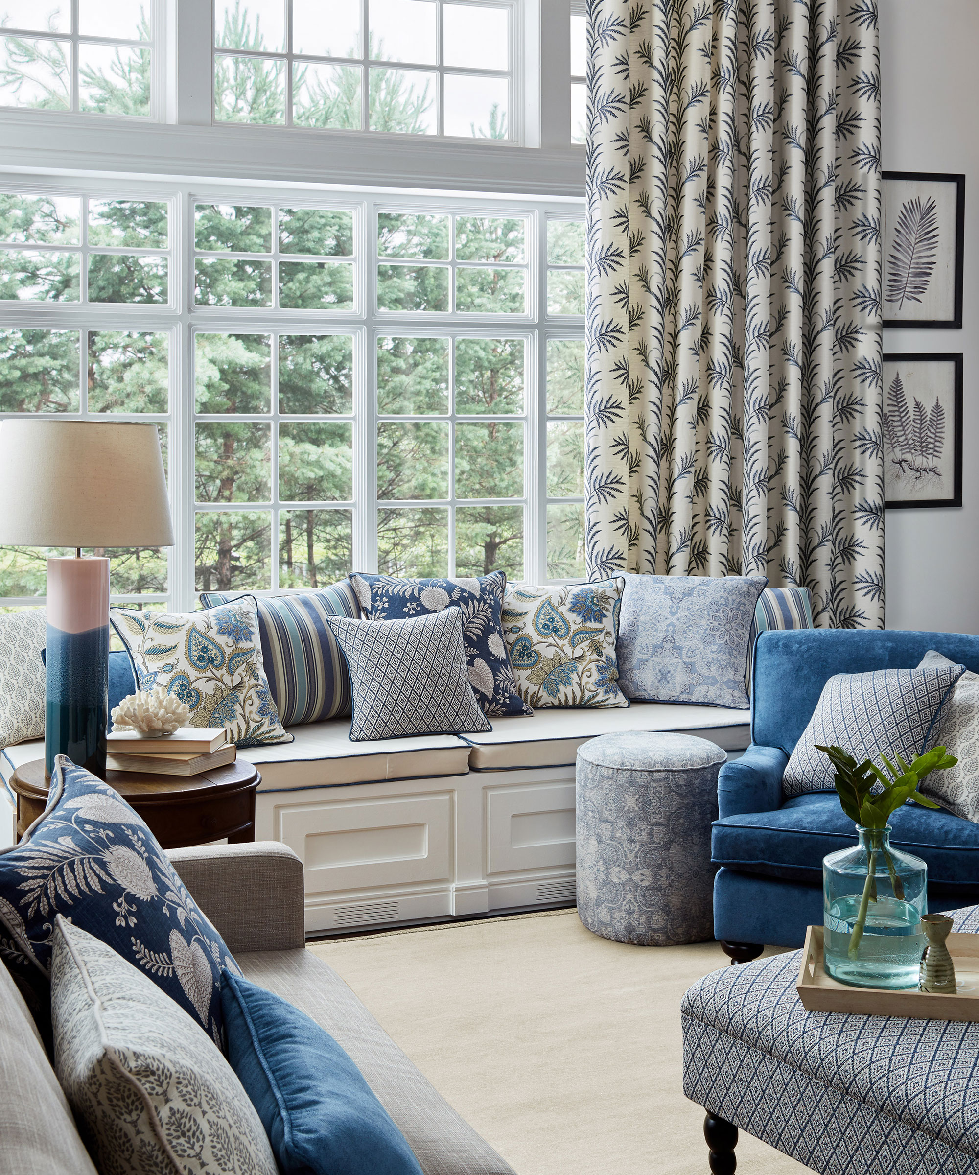 blue living room scheme with full length curtains and window seat with cushions
