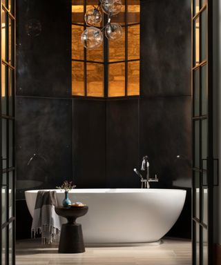 bathroom with freestanding tub, steel walls and steel framed doors
