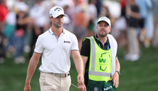 Thomas Detry walks off the green next to his caddie