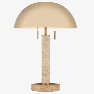 A gold table lamp with a rounded metal top