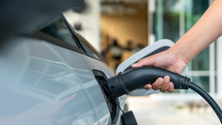 Hand putting an charger in an car