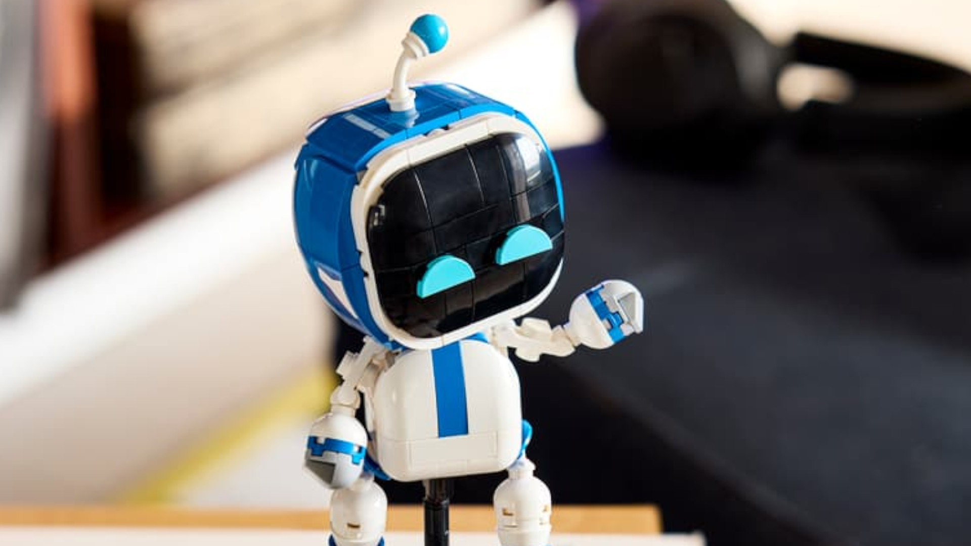 Lego Astro Bot waving in a home environment