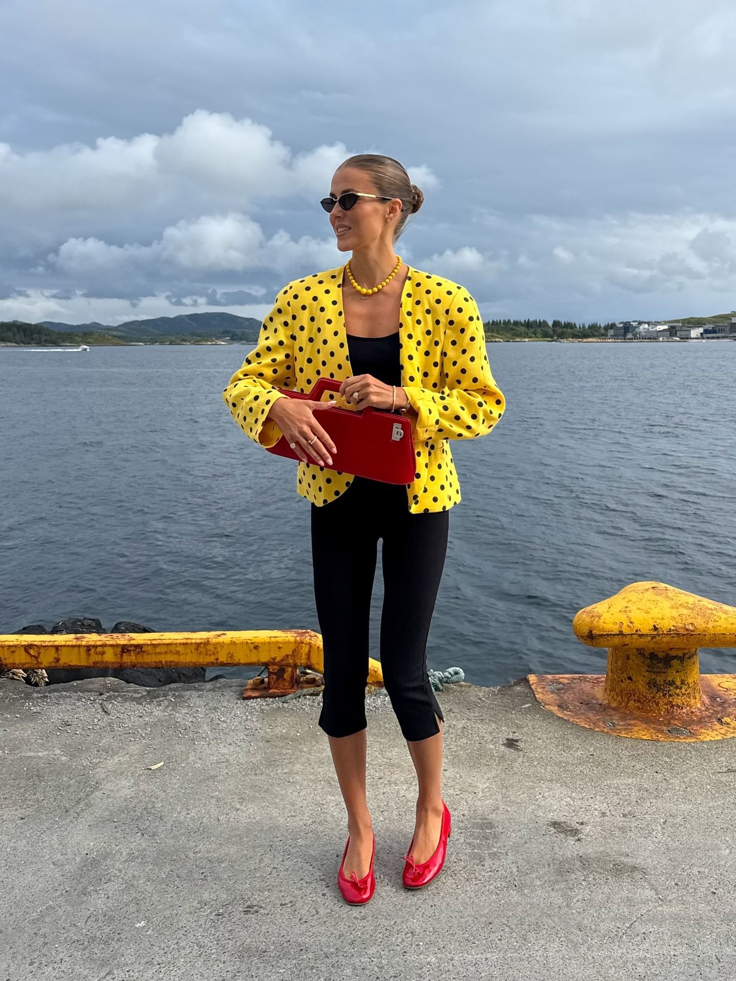 Woman holding a red handbag.