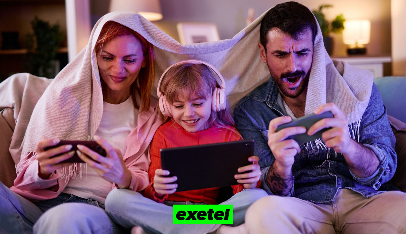 Family of three sitting on the couch using different devices with the green Exetel logo on the bottom