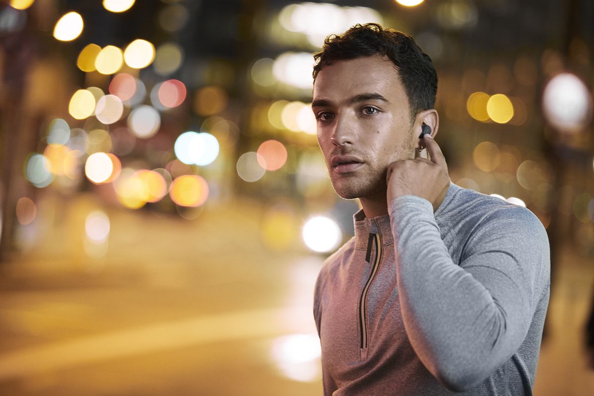 Man wearing Jabra earbuds in the city 