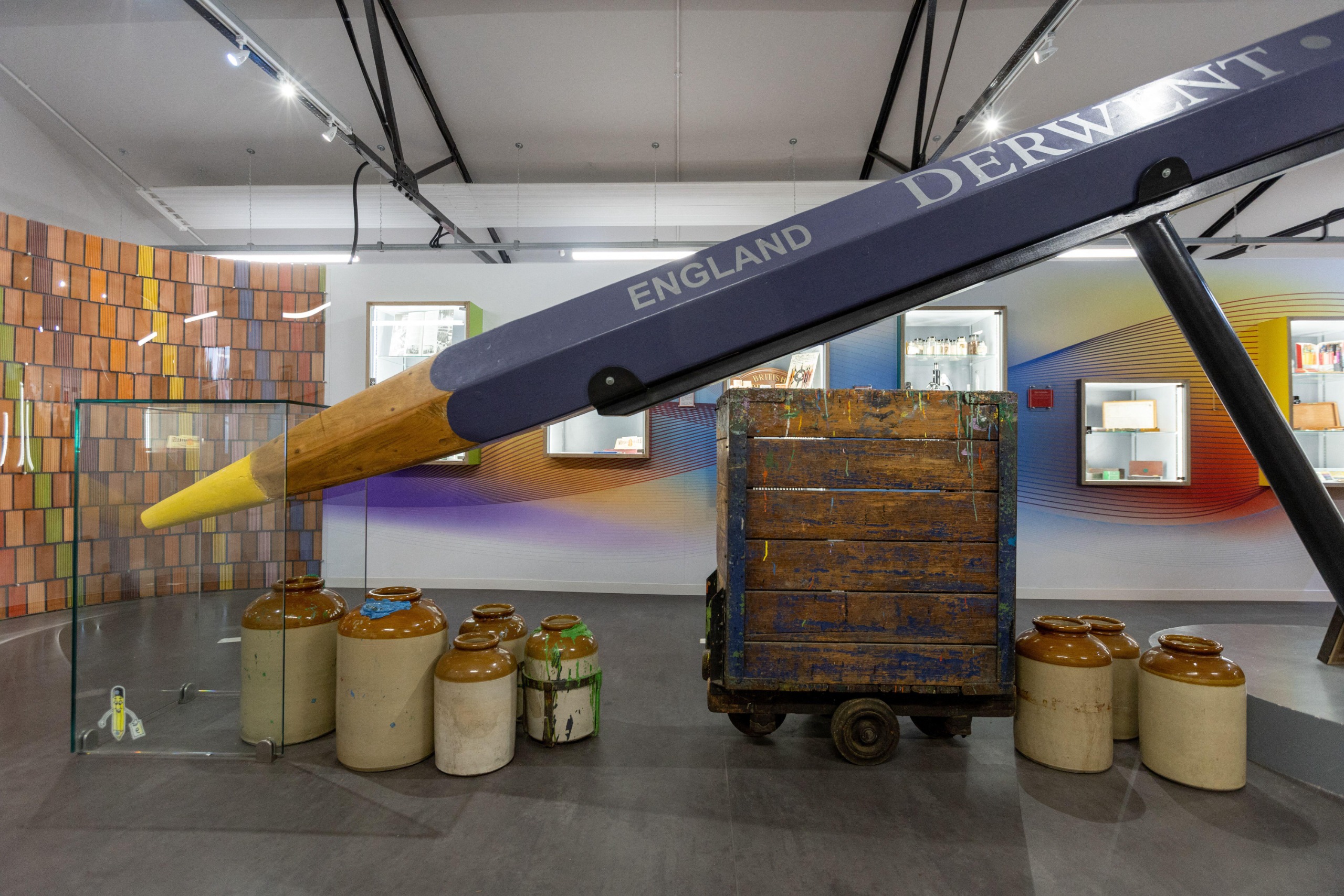 A large pencil, like the biggest pencil you've ever seen, in a room
