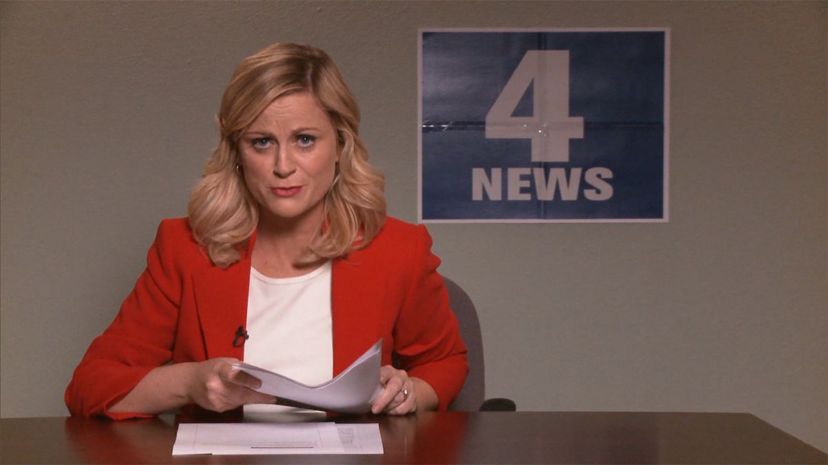 Leslie Knope (Amy Poehler) pretends to be a news anchor in Parks and Recreation