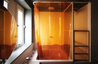 Lubetkin tower apartment bathroom with orange curtain