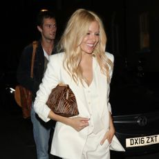 Sienna Miller wears a zebra print bag.