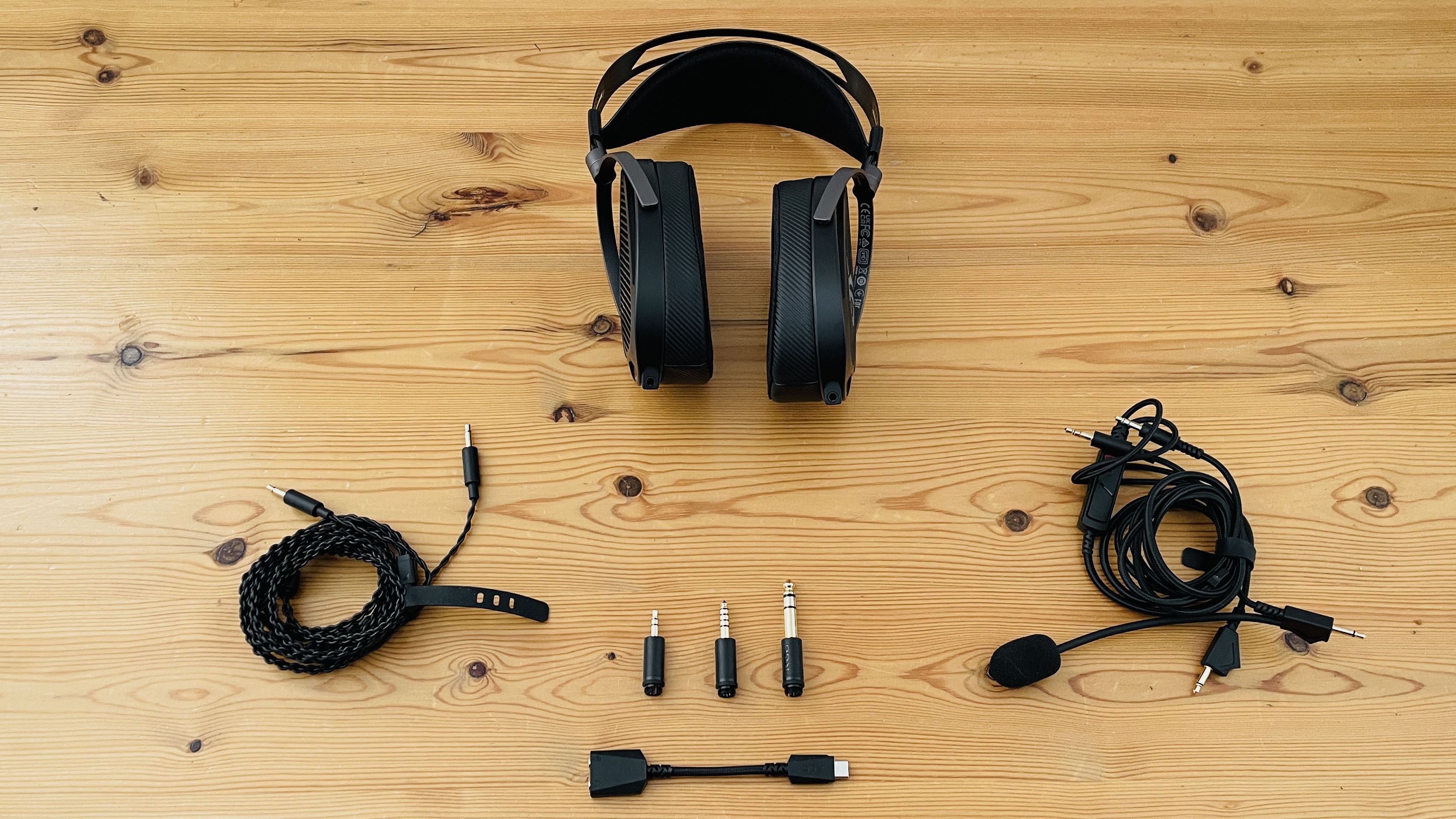 A picture of the Asus ROG Kithara audiophile wired gaming headset on a wooden surface.