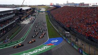 A general view as Max Verstappen of the Netherlands driving the (1) Oracle Red Bull Racing RB20 leads Lando Norris of Great Britain driving the (4) McLaren MCL38 Mercedes and the rest of the field into turn one at the start during the F1 Grand Prix of Netherlands at Circuit Zandvoort on August 25, 2024 in Zandvoort, Netherlands.