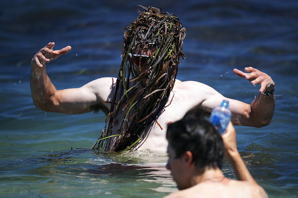 Nathan Haas of Australia and Team Katusha Alpecin cools off in the ocean after stage three of the 2018 Tour Down Under