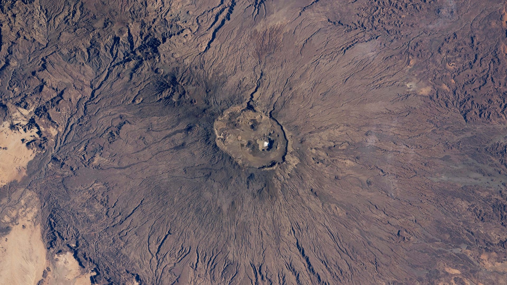 A surprising slab of salt shines at the summit of the Sahara's tallest peak — Earth from space