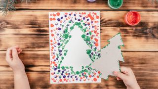 children's handmade christmas card of a christmas tree using a template stencil