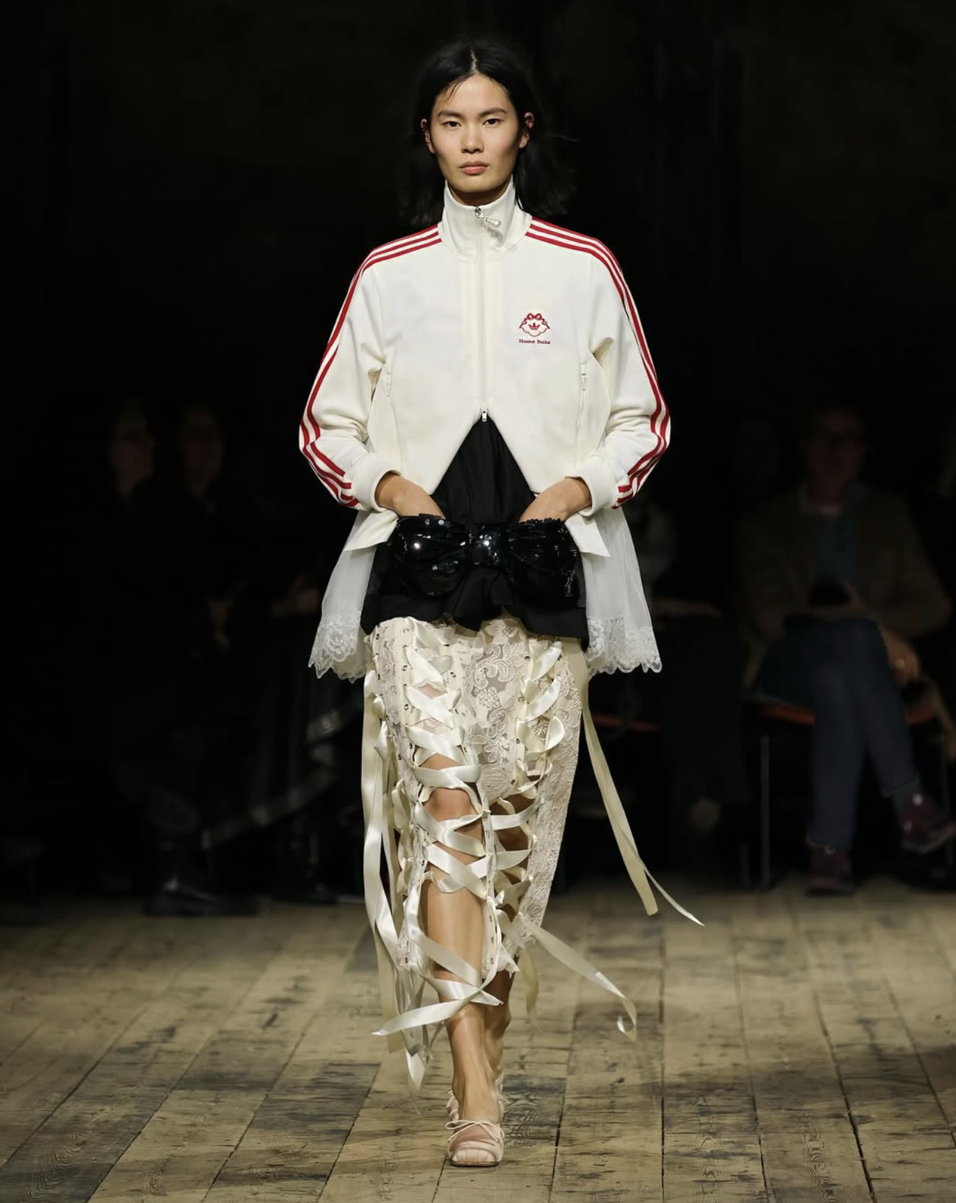model walks Simone Rocha AW26 runway in lace skirt and football hoodie