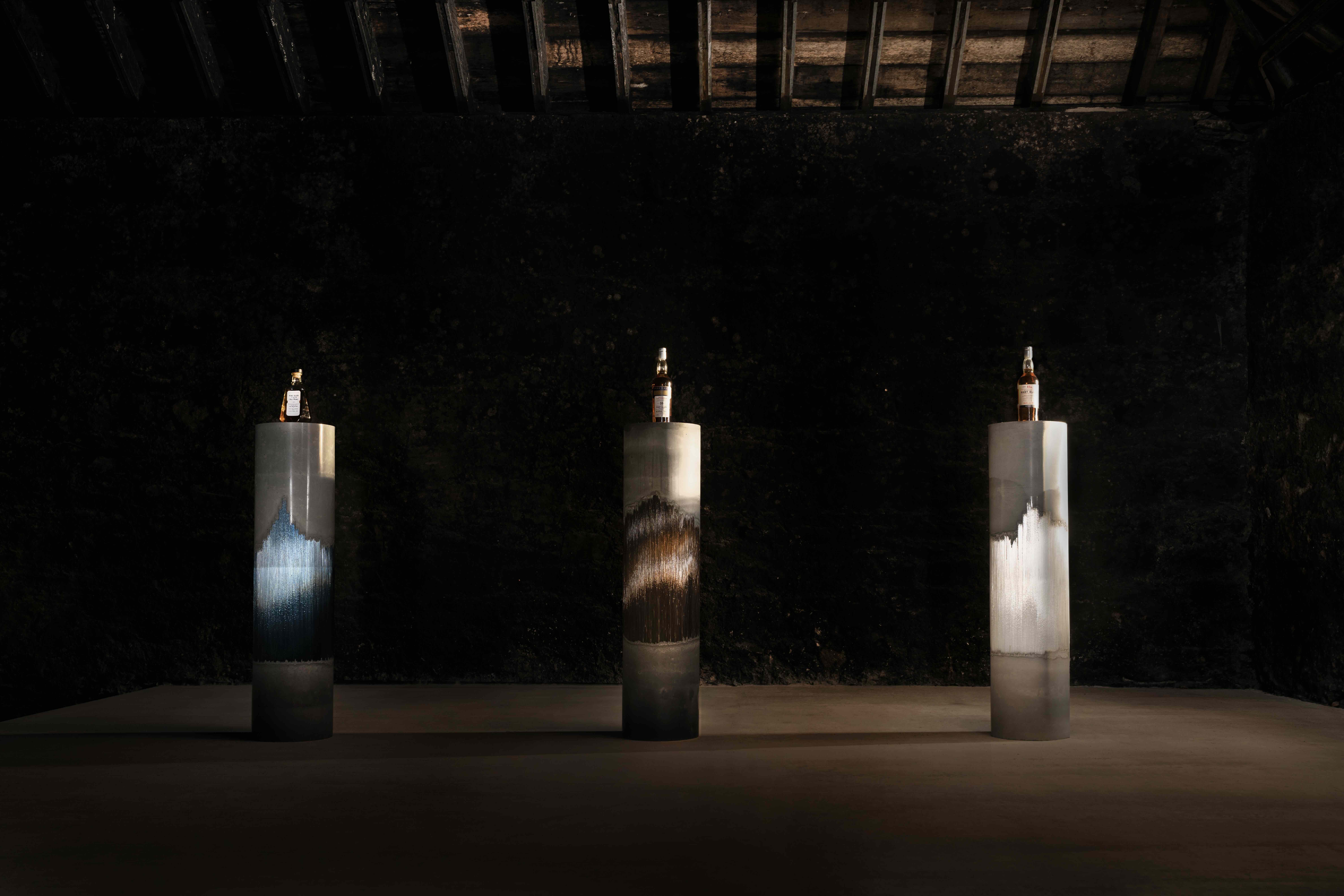 Port Ellen whisky bottles on artist-designed columns