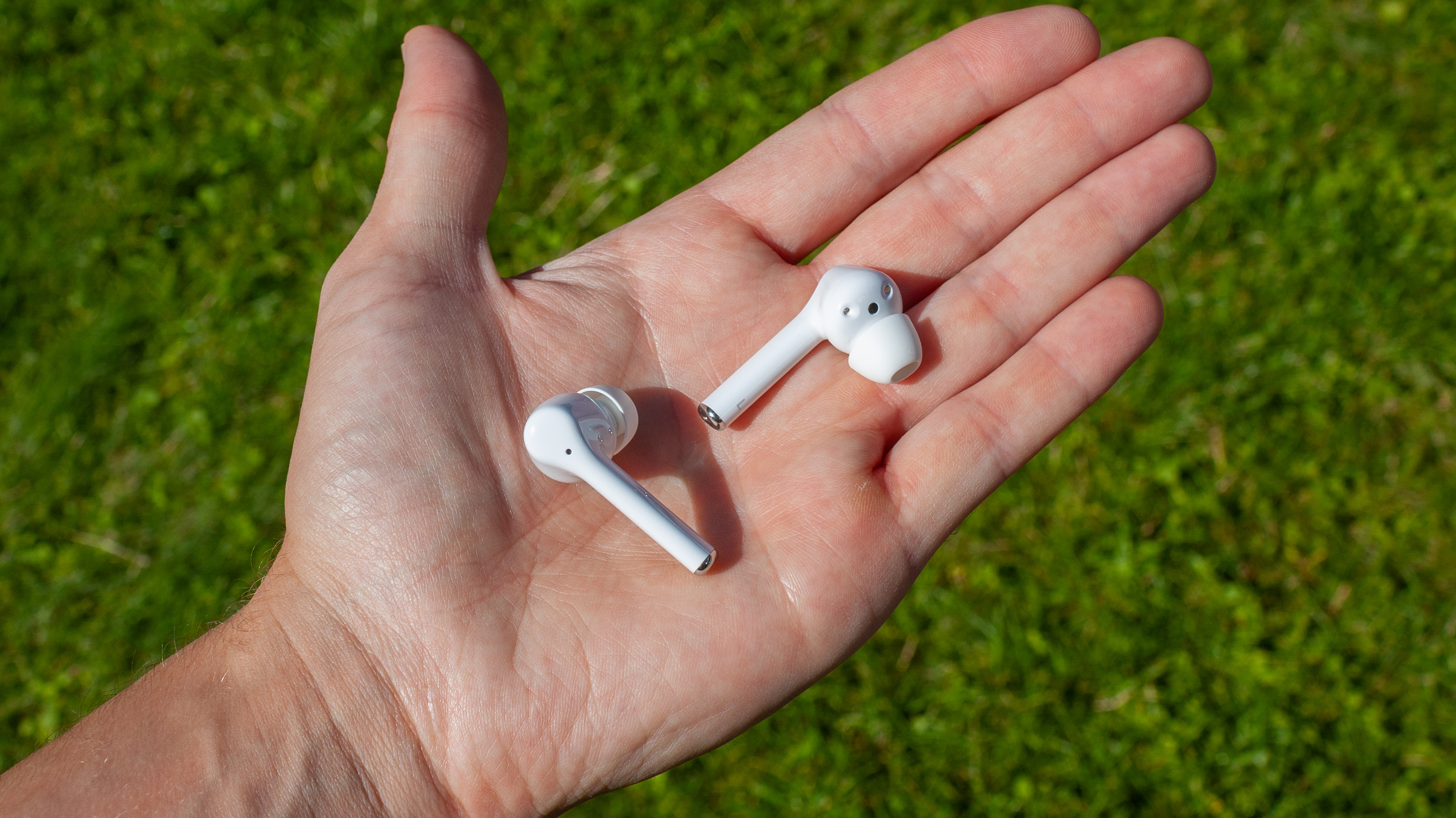 the Huawei FreeBuds 3i wireless earbuds in an open palm