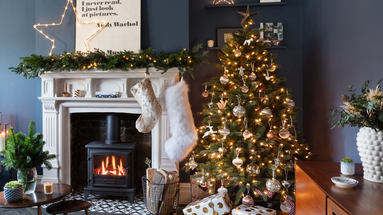 A Christmas-decorated living room with a Christmas tree and a fireplace