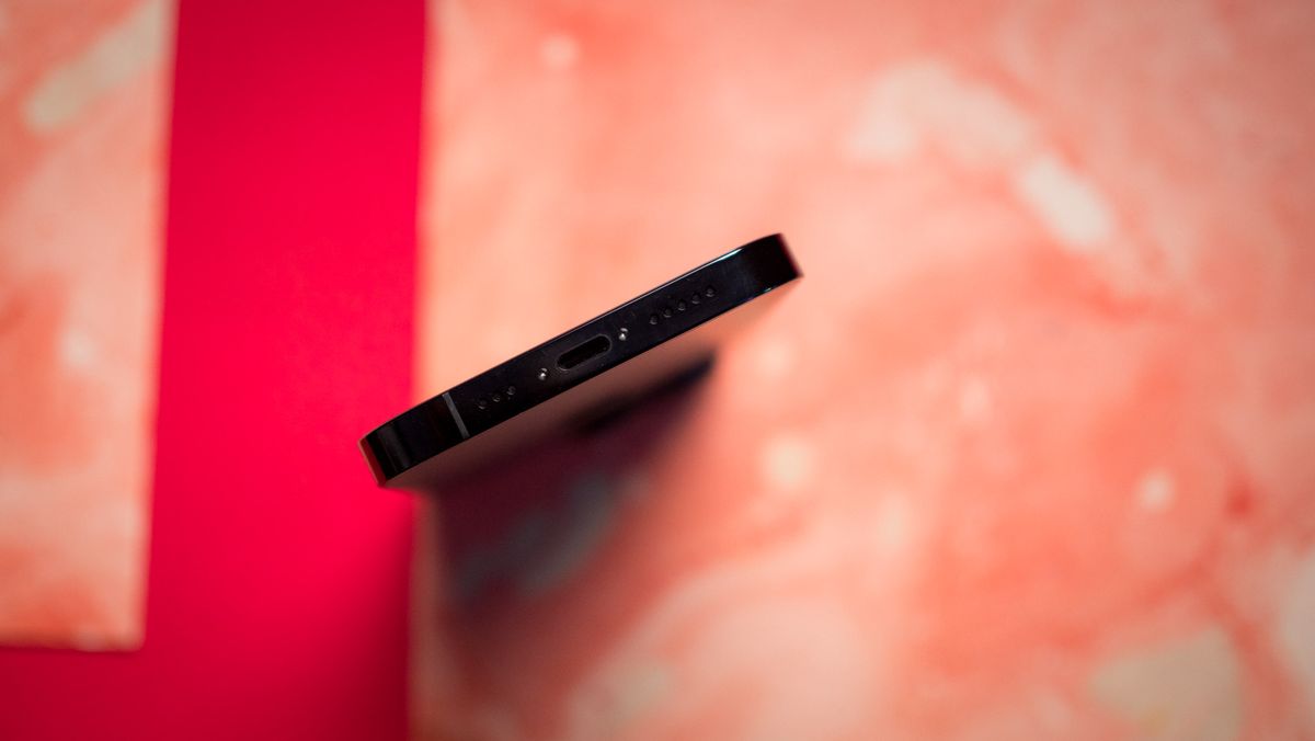 iPhone 14 Pro charging port on red background