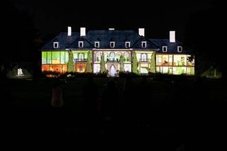 Epson projection mapping lights up this haunted house in eerie colors.