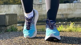 Woman's feet wearing Saucony Endorphin Shift 3 road running shoes - front view