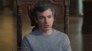 Nathan Fielder sits apprehensively in an ornate chair in The Rehearsal S2 E2 - "Star Potential."
