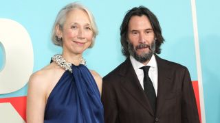 From left to right: Alexandra Grant and Keanu Reeves standing together and smiling at the Good Fortune special screening in New York City on October 13, 2025. 
