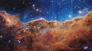 A composite image of the Cosmic Cliffs in the Carina Nebula, created with the Webb telescope’s NIRCam and MIRI instruments.